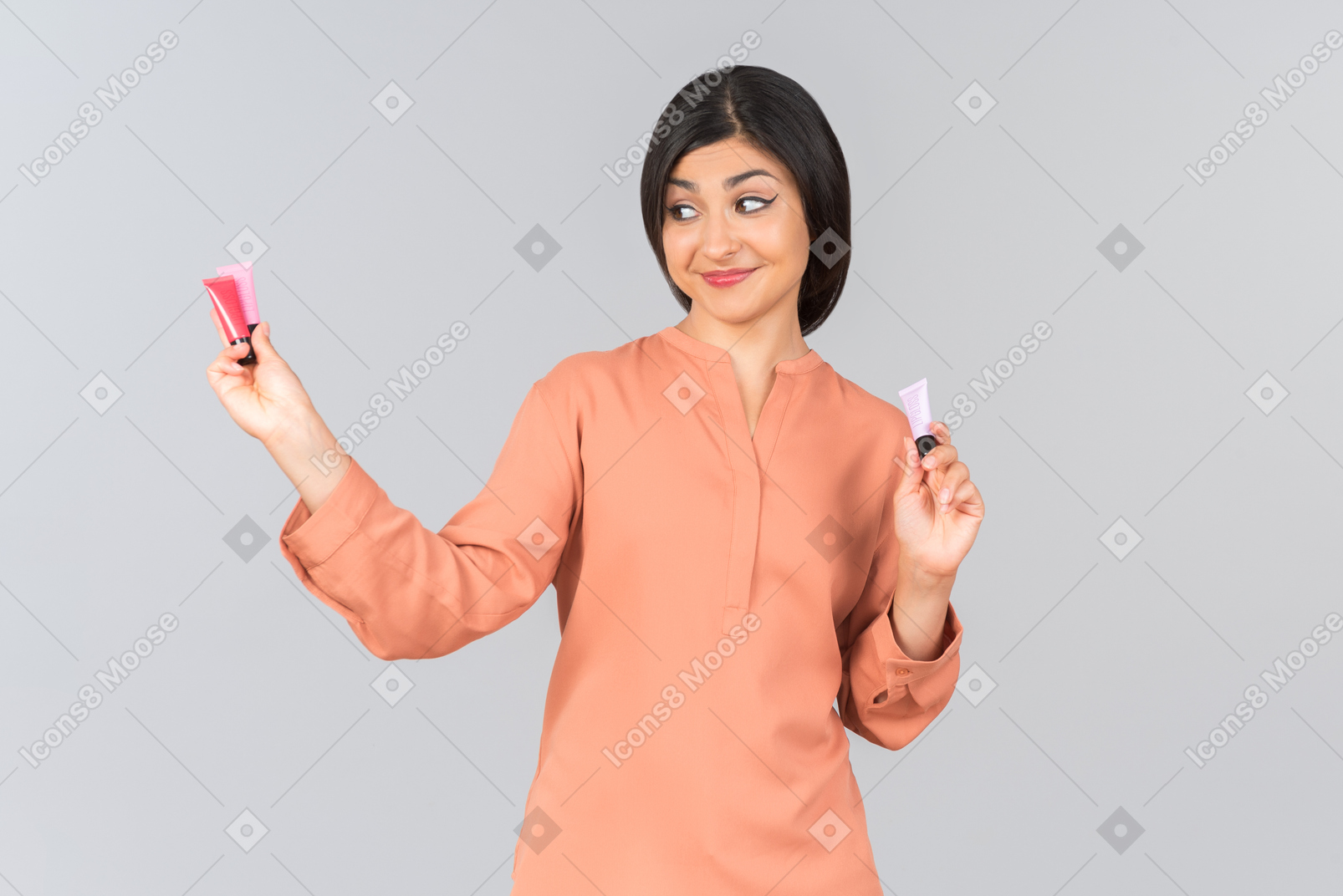 Indian woman comparing lip balms she's holding