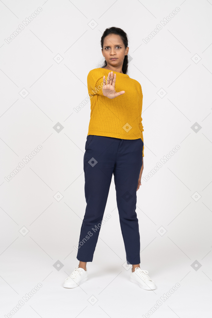 Front view of a girl in casual clothes showing stop gesture