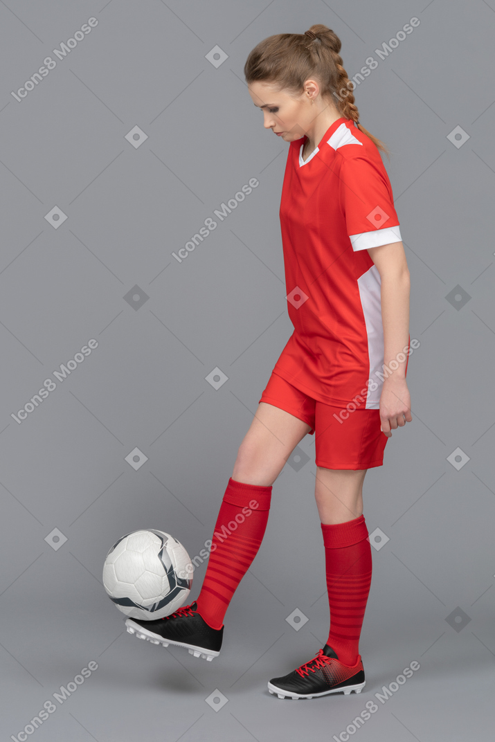 Holding a football ball on a foot