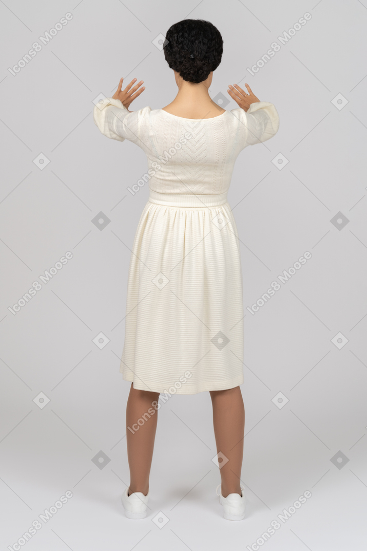 Woman standing backwards keeping hands in front