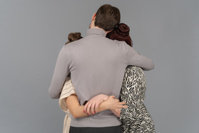 Warm embraces from two young women and one young man