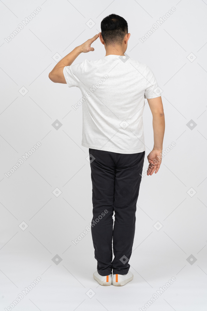 Rear view of a man in casual clothes saluting with hand