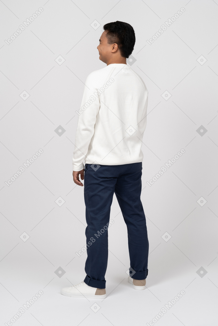 A man wearing a white sweater and blue pants