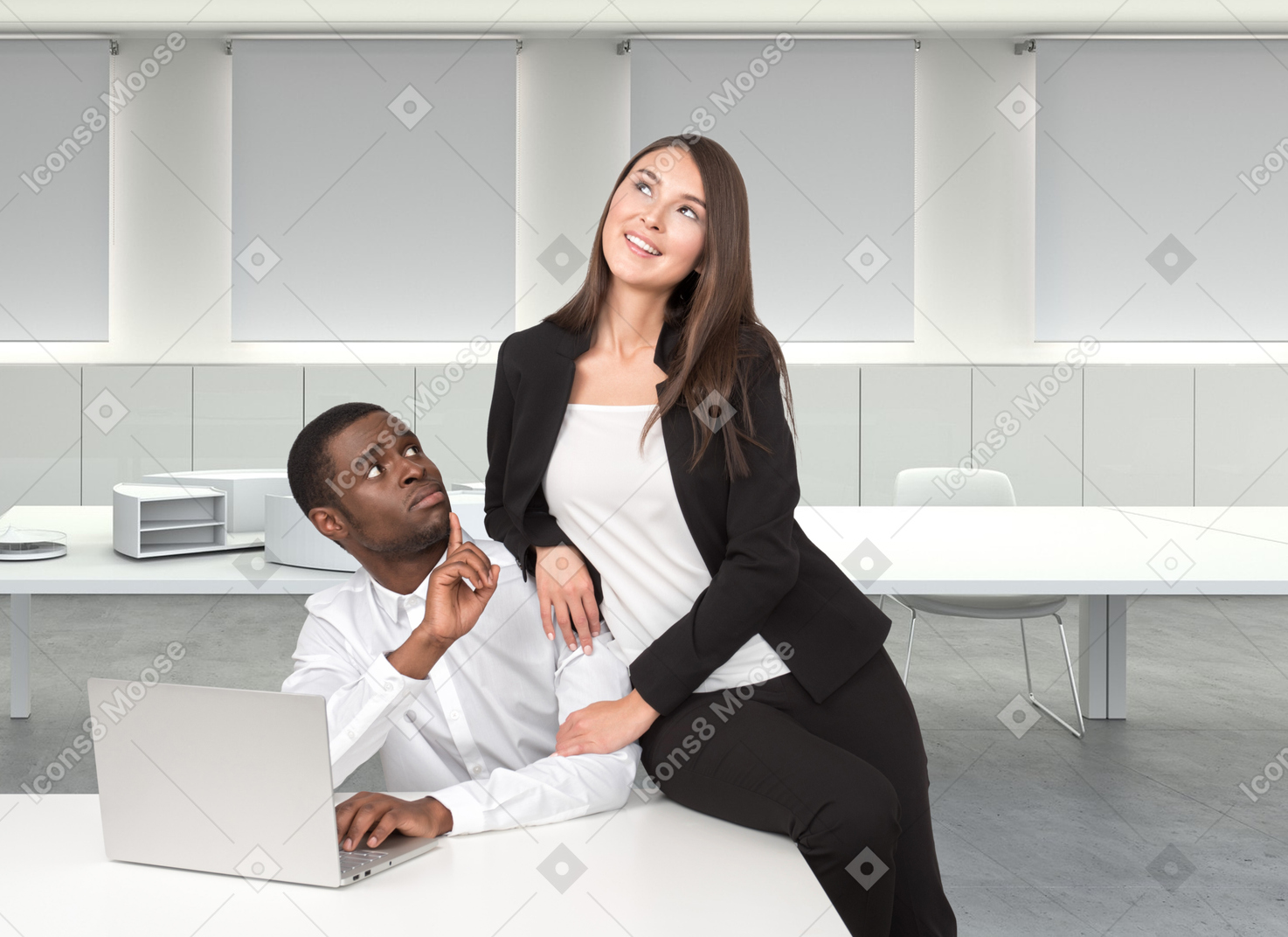 A man sitting behind the desk with laptop and woman sitting on top of the desk