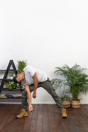 Handsome athletic man posing on the background of the apartment