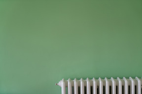 Green wall with white house heater