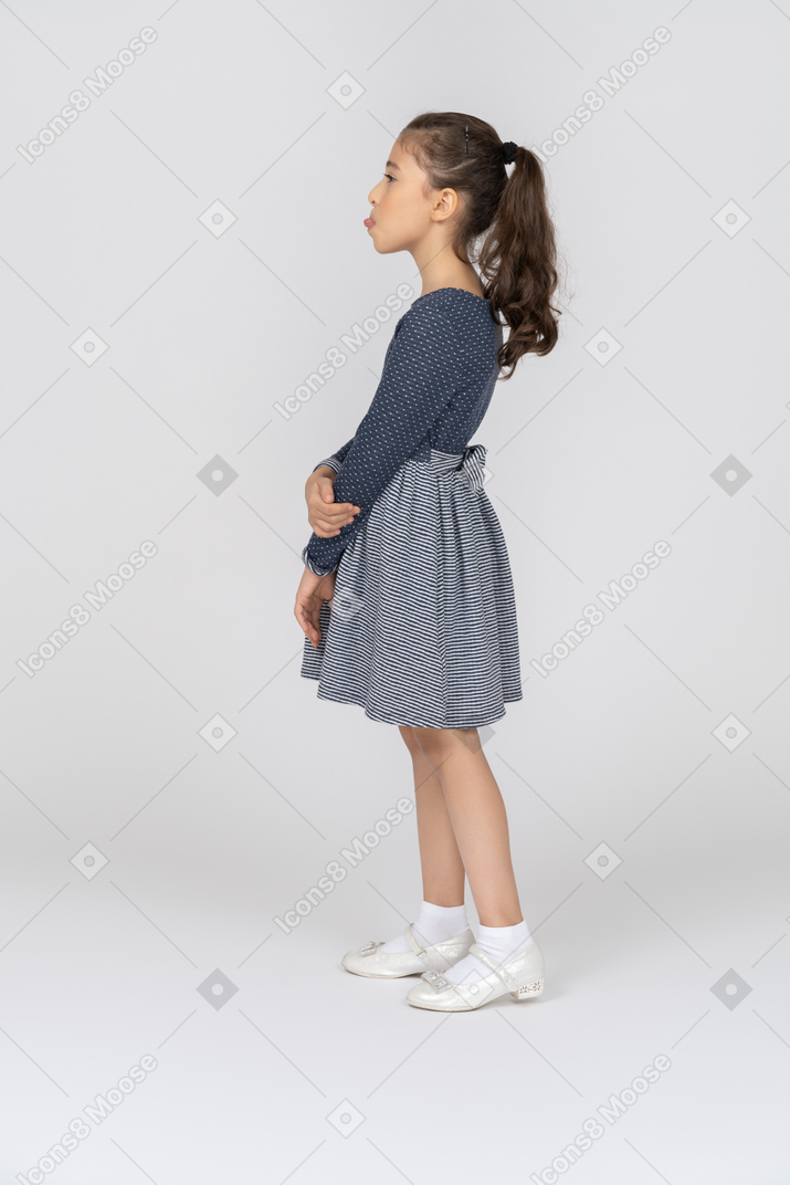 Side view of a girl showing the tip of the tongue