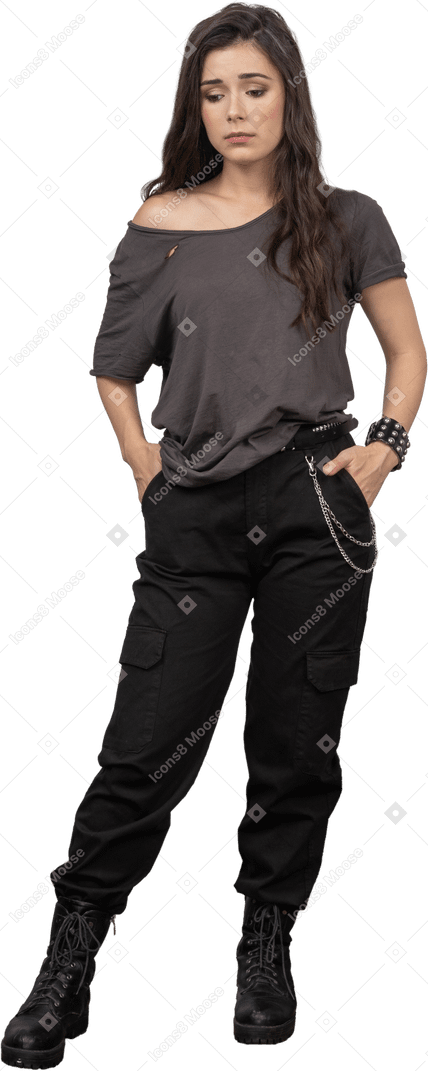 Front view of a miserable female rocker putting hands in pockets