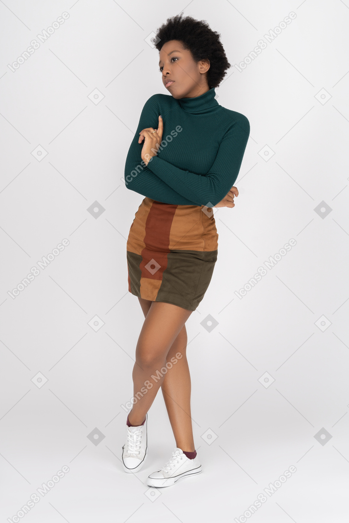 Cold teenage girl posing with folded hands