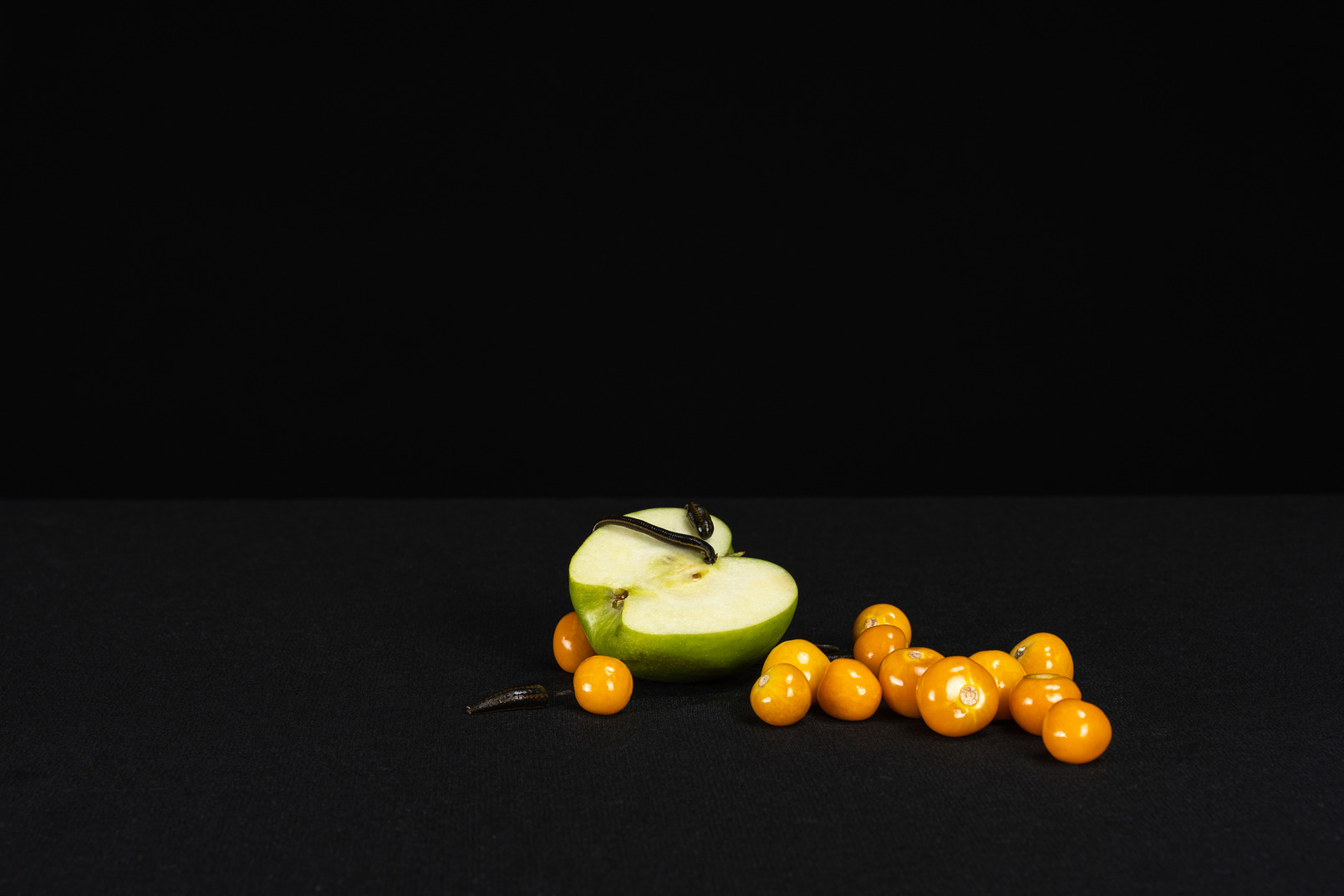 A composition of green apple, leech and yellow cherry tomatoes