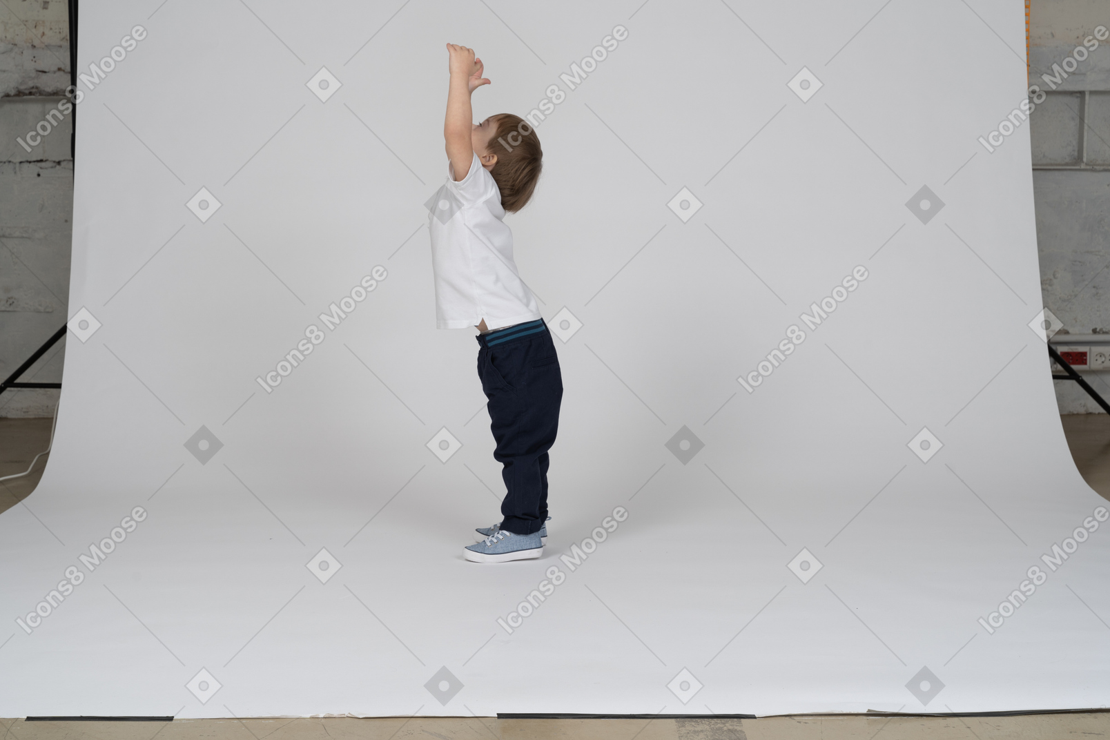 Side view of a little boy stretching