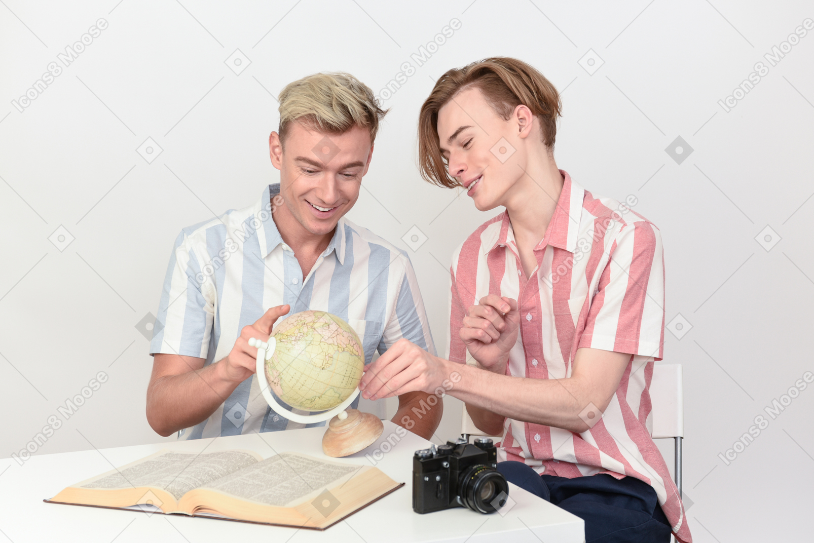 Gay couple looking at globe
