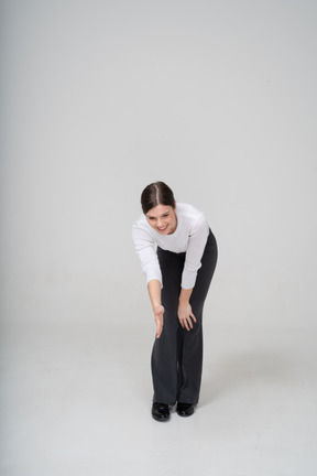 Front view of a woman bending down