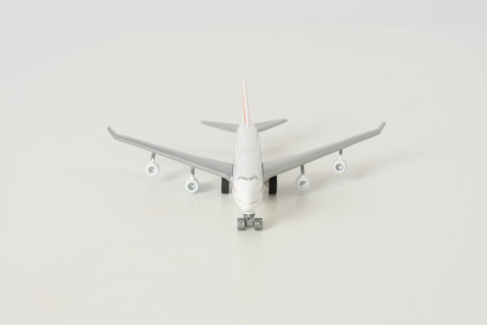 Toy airplane on grey background