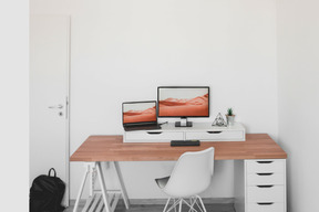 A desk with a computer and a chair