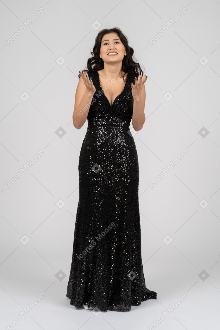 Wondering woman in black evening dress
