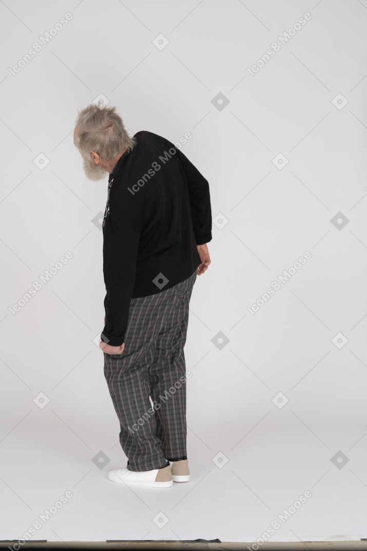 Side view of an old man bending to the left