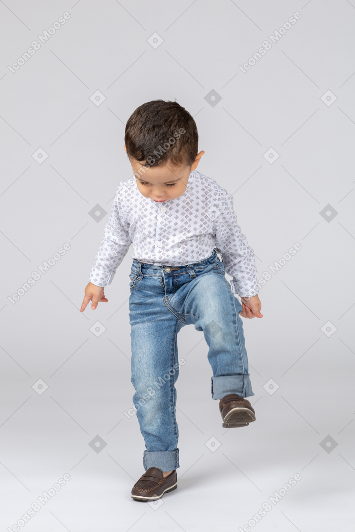 Cute little boy raising foot