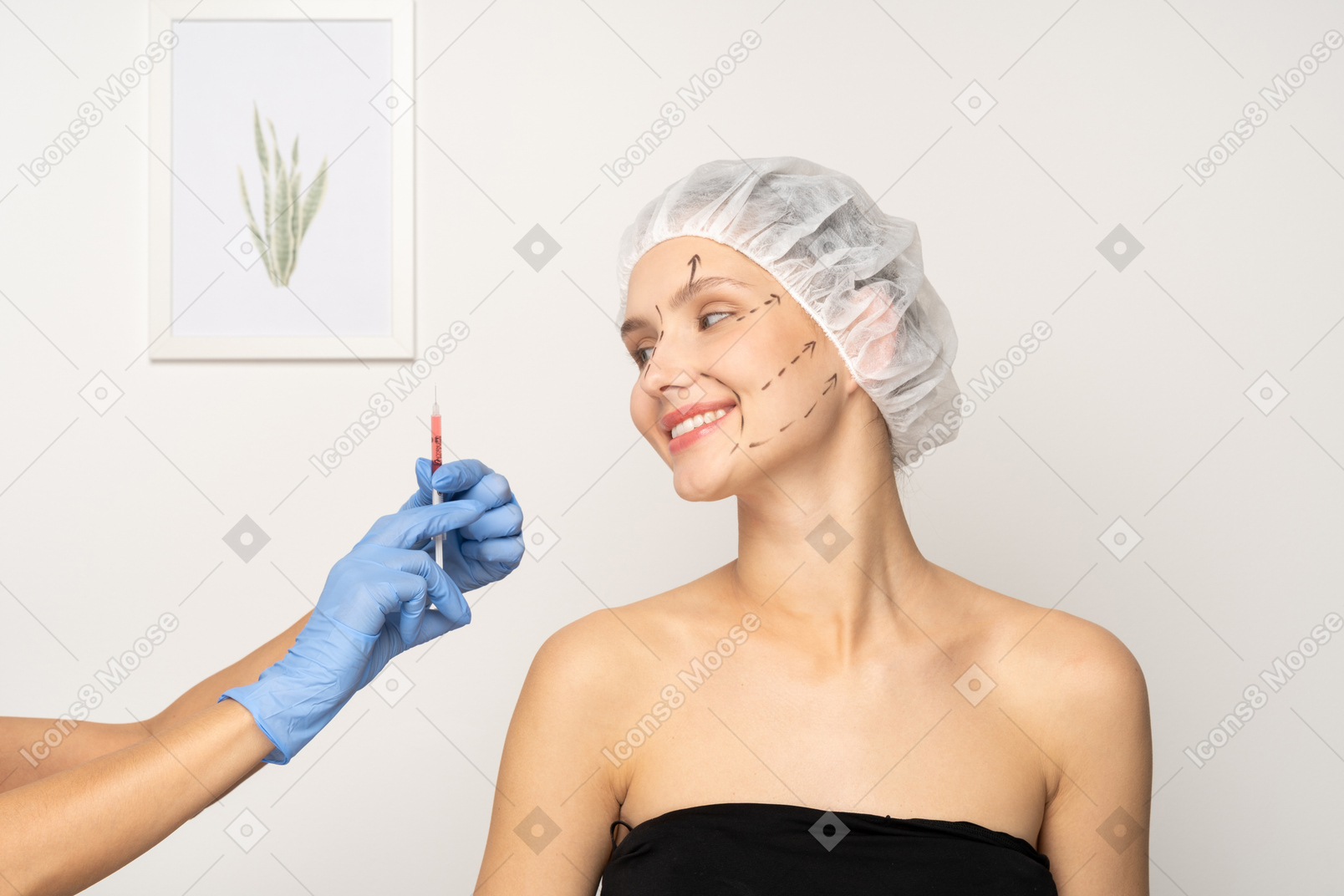 Young woman smiling and gloved hand holding up syringe