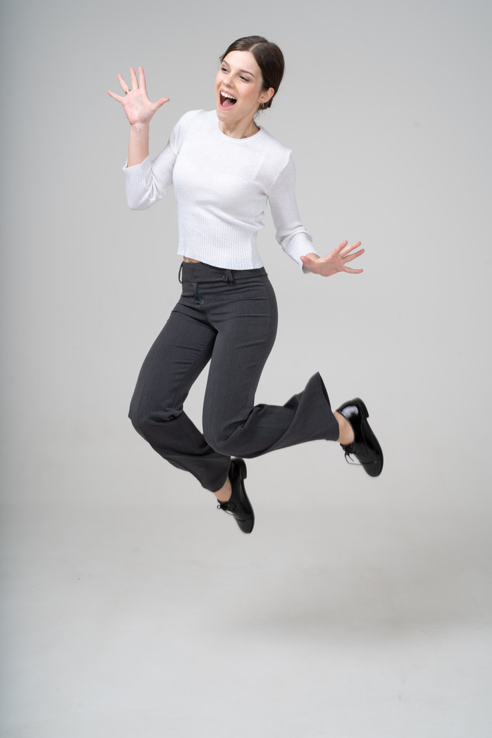 Front view of a woman in suit jumping