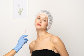 Young woman about to get botox injection