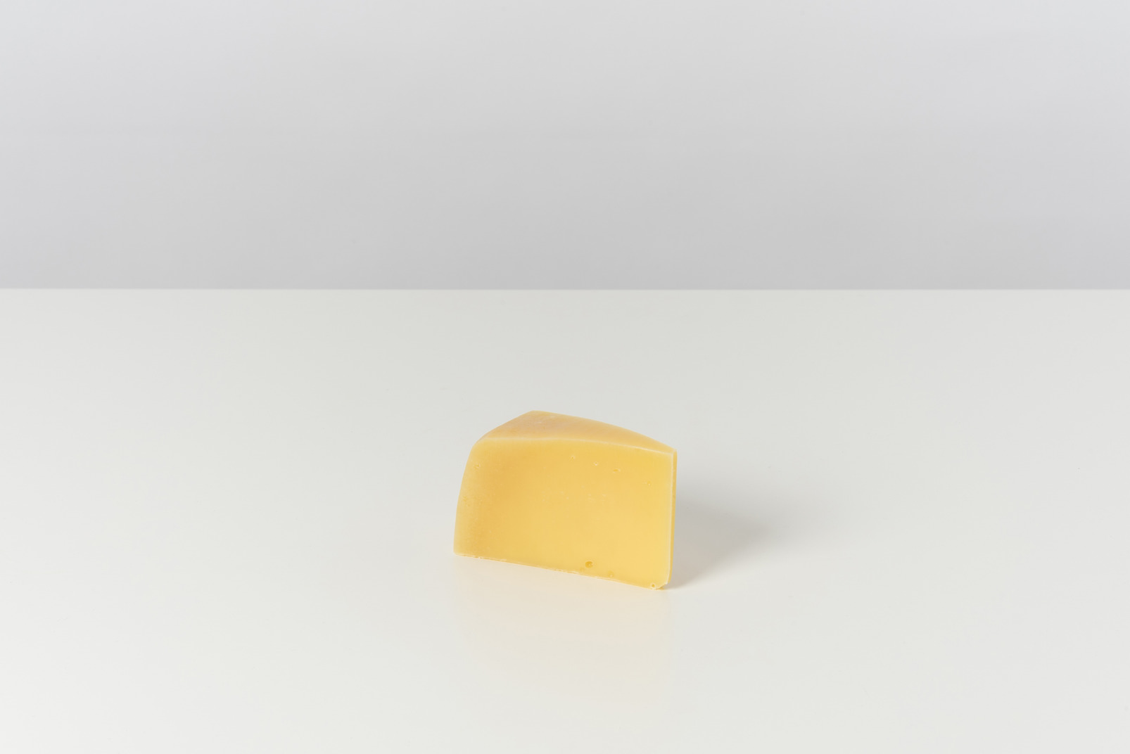 Piece of cheese on grey background