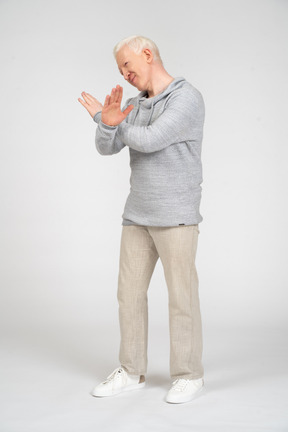 Side view of man showing enough gesture