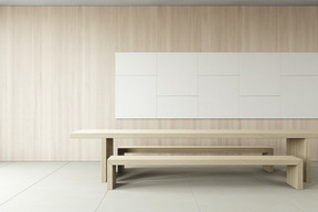 A simple minimalistic room with wooden tables and benches on a simple grey floor