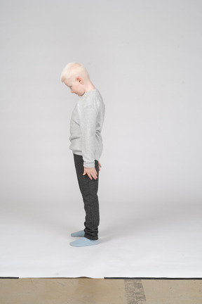 Side view of a boy with his head down