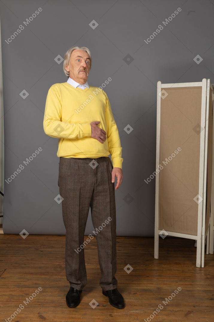 Front view of an old staring scared man