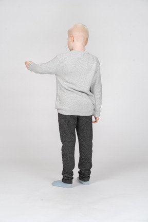 Back view of a boy reaching out for something