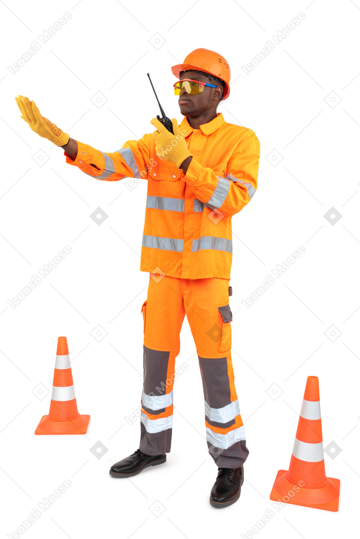 Construction worker holding radio phone and making some announcement