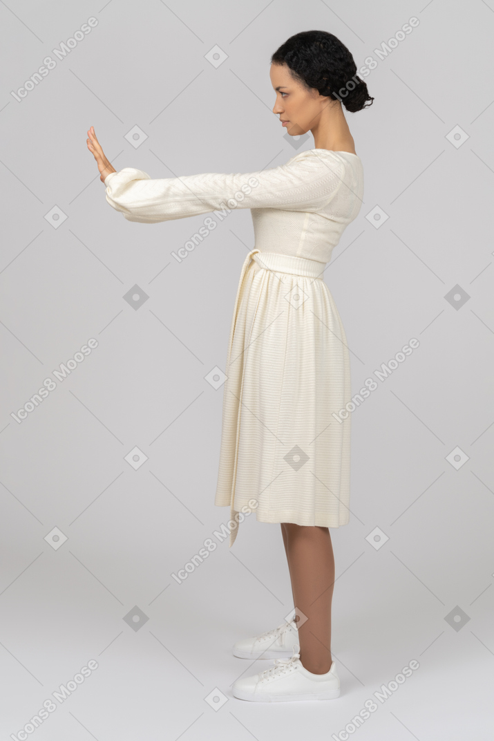 Woman standing sideways keeping hands in front