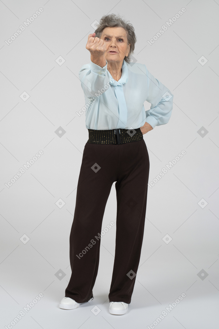Old lady threatening with fist