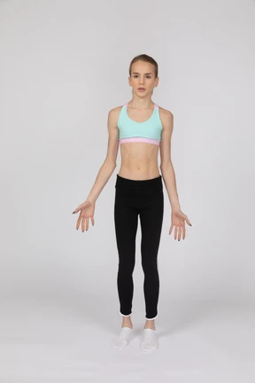 Side view of a teen girl in sportswear raising hand and arguing
