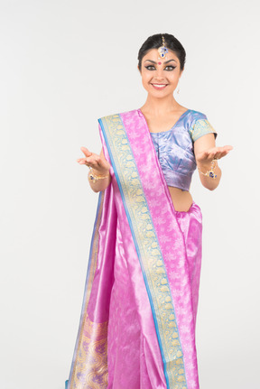 Happy looking young indian woman in purple sari