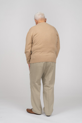 Vista traseira de um velho em roupas casuais andando