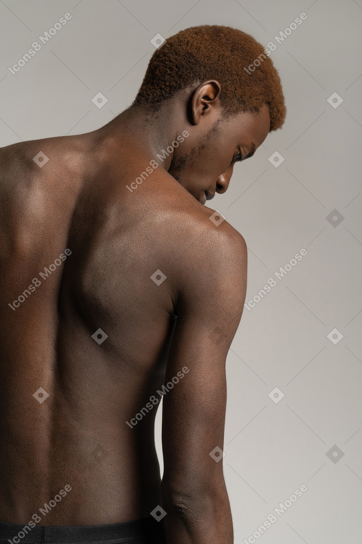 Back view of topless young man looking down