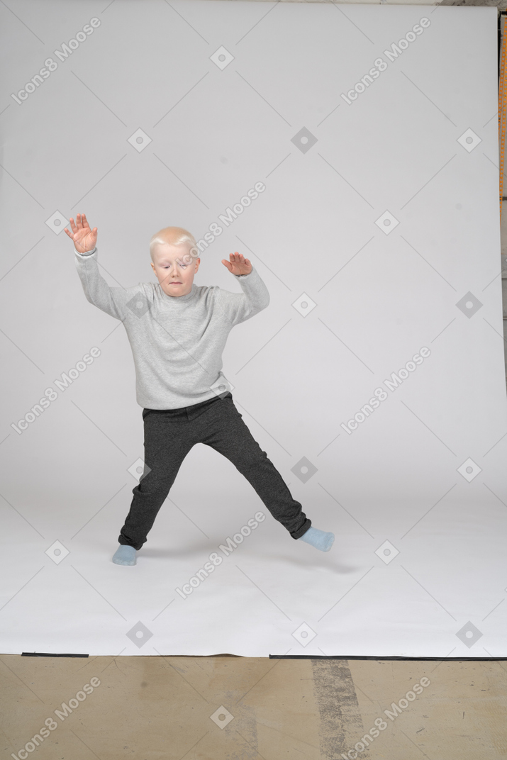 Boy jumping with his legs apart