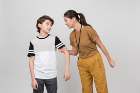 Pe female teacher holding her student's arm