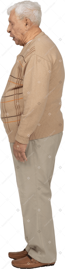 Vista lateral de um velho em roupas casuais fazendo caretas