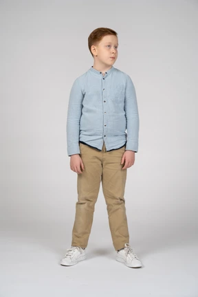 Front view of boy in casual clothes looking aside