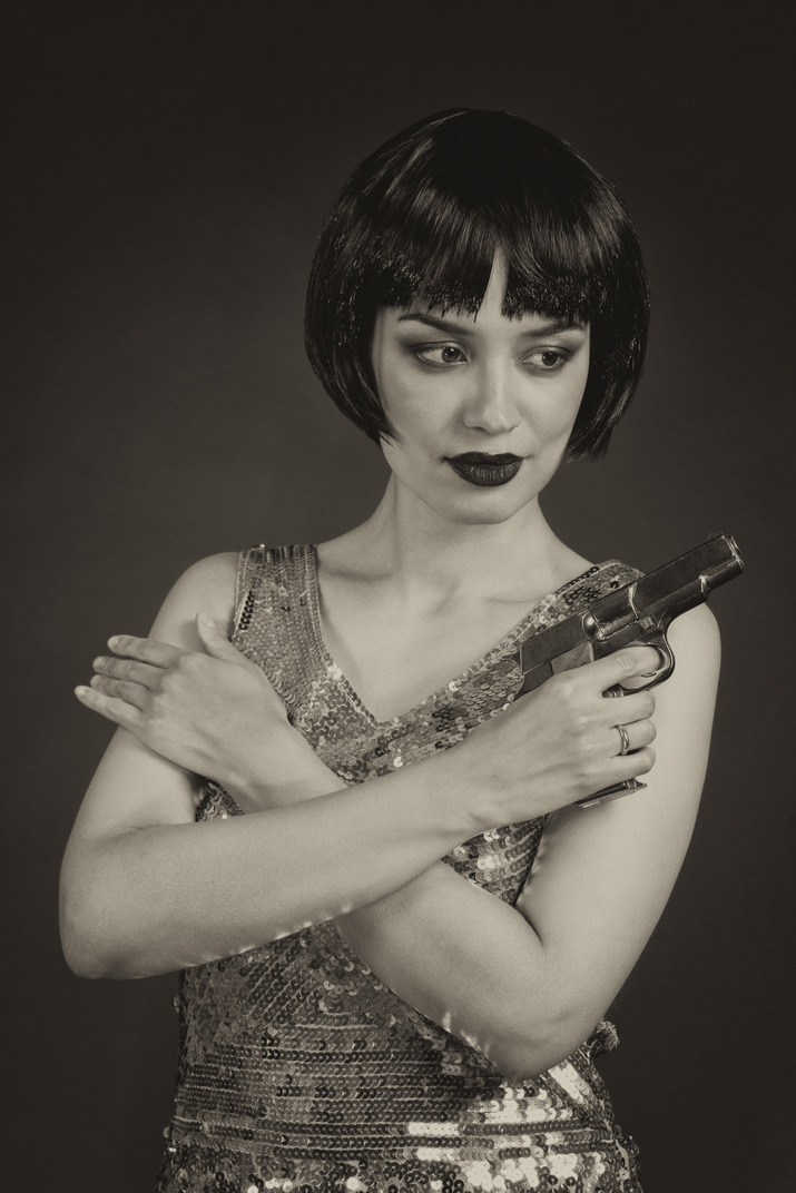 Retro-styled woman with a gun
