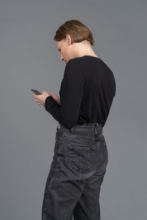 Back view of a person using smartphone