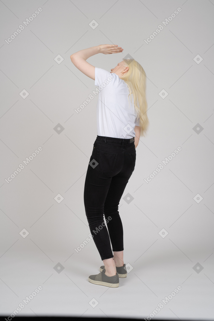 Back view of girl covering face from light