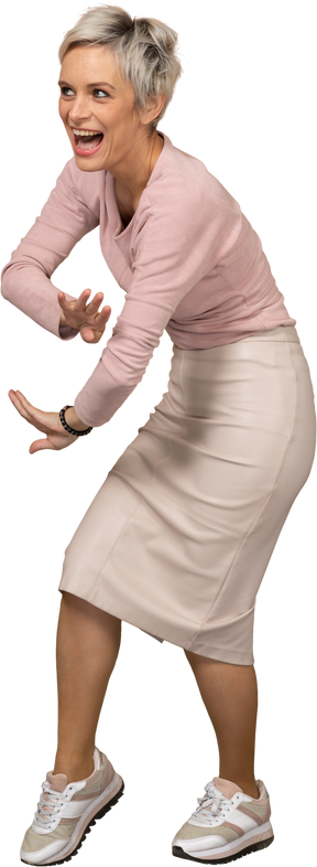 Side view of a happy woman in casual clothes bending down and gesturing