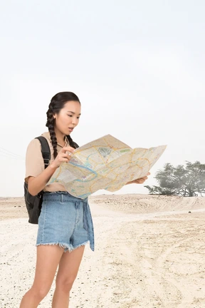 A woman looking at a map in the desert