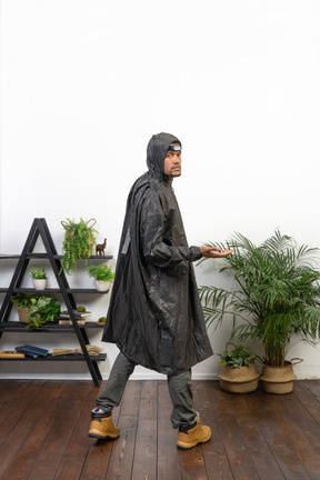 Man in raincoat looking over shoulder