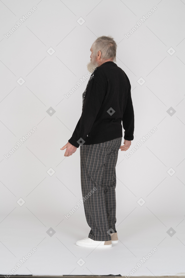 Side view of old man spreading arms