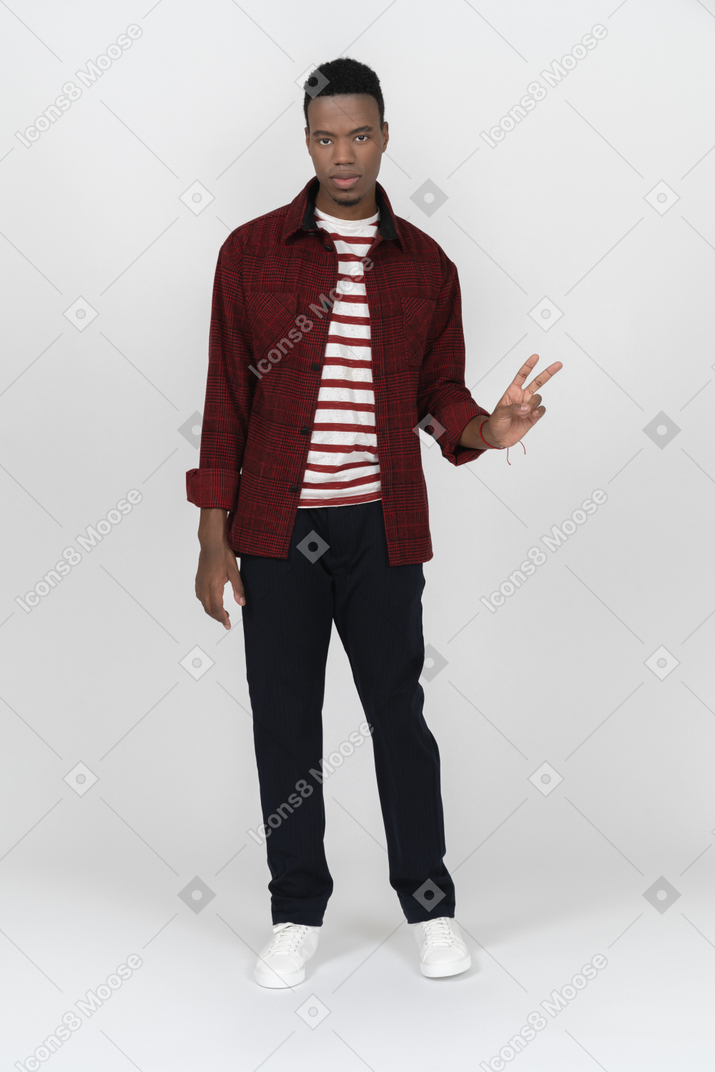 Young man showing v sign
